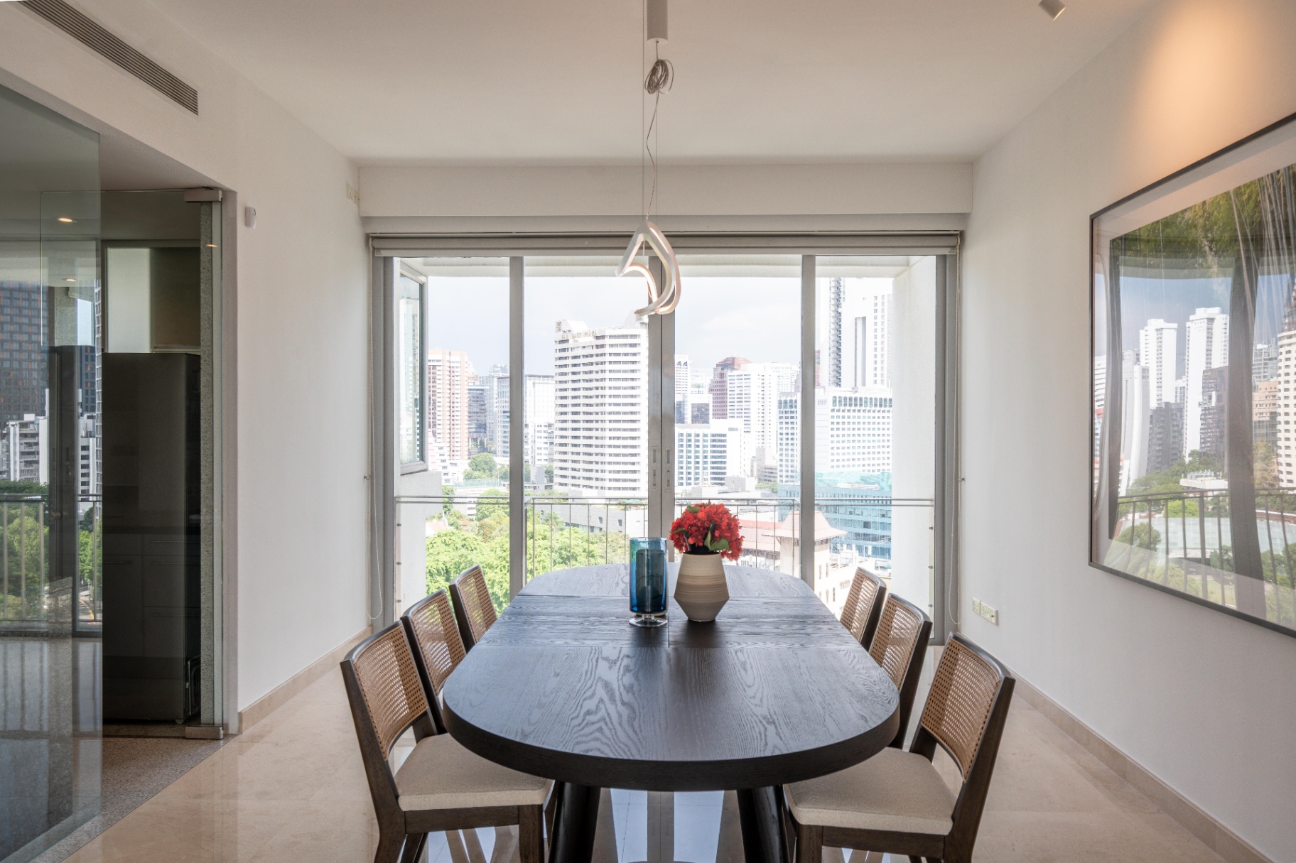 Draycott 8 — dining area opening onto balcony with greenery and skyline