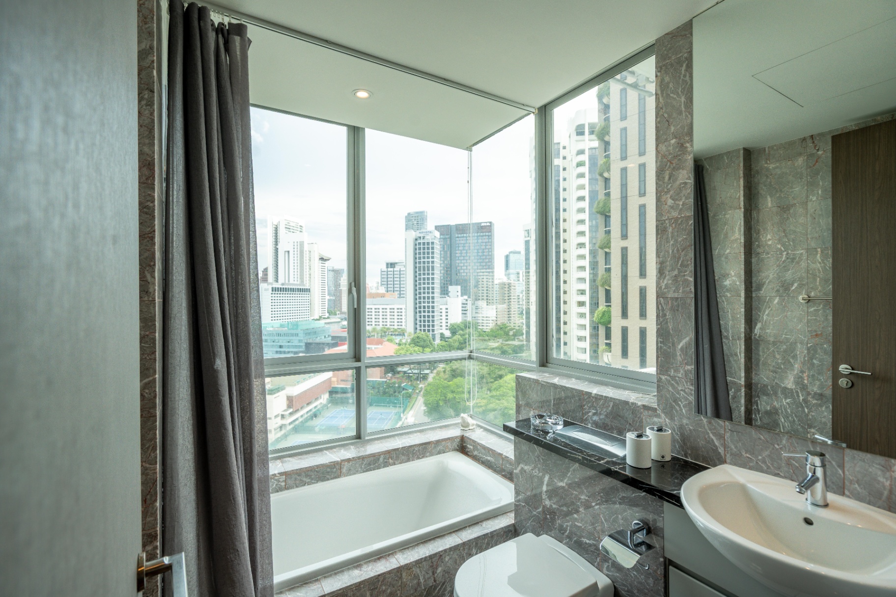 Draycott 8 — marble ensuite bathroom with city outlook