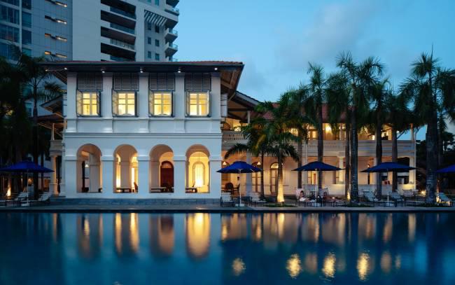 Draycott 8 Clubhouse — restored colonial bungalow at dusk, reflected in the lap pool